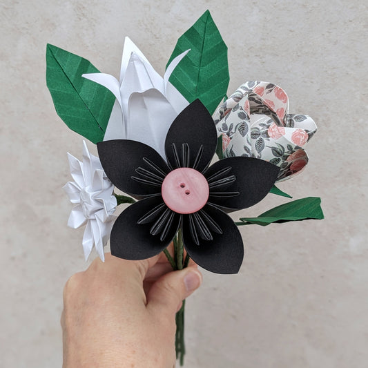 Colourful origami paper flower bouquet with leaves