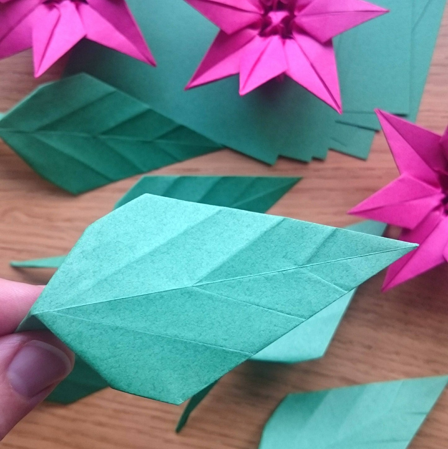 Pink origami paper plant, faux poinsettia in pot