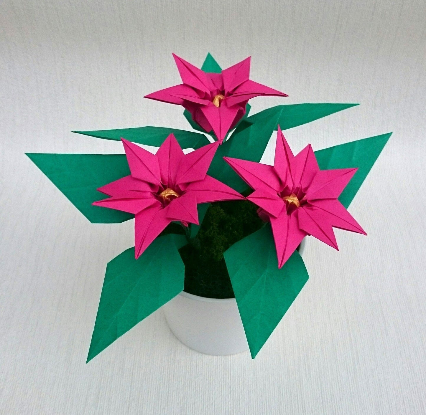 Pink origami paper plant, faux poinsettia in pot