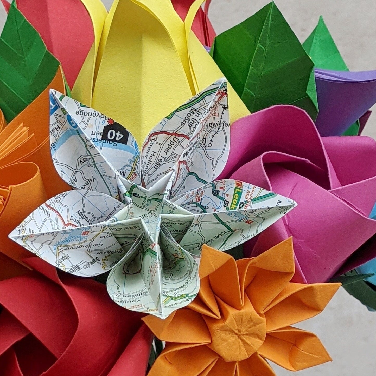 Colourful origami wedding bouquet with upcycled map paper flowers