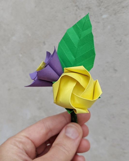 Origami paper buttonhole with a yellow rose, purple daisy and green leaf
