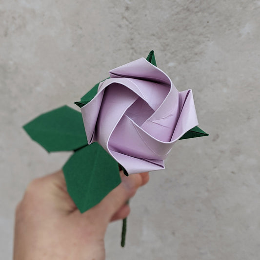 Pastel lilac origami paper rose on a long wire stem with origami leaves