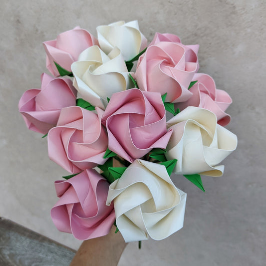A big bouquet of one dozen (12) origami paper roses in pastel pinks and ivory