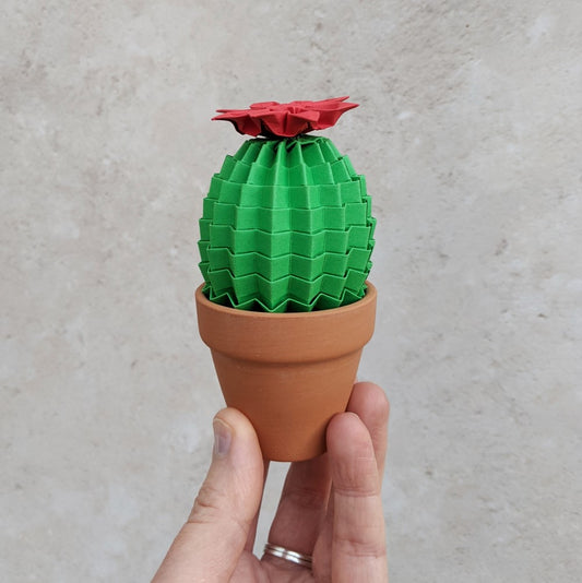 cute mini green origami cactus plant topped with a red paper flower in a small terracotta pot