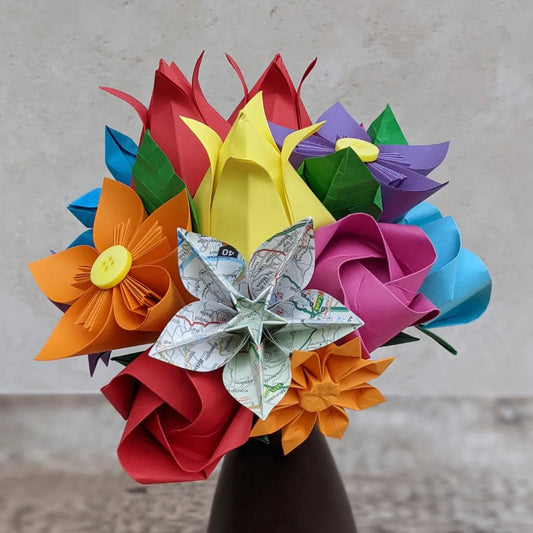 Multi-coloured origami flower bouquet including a star flower made from map paper
